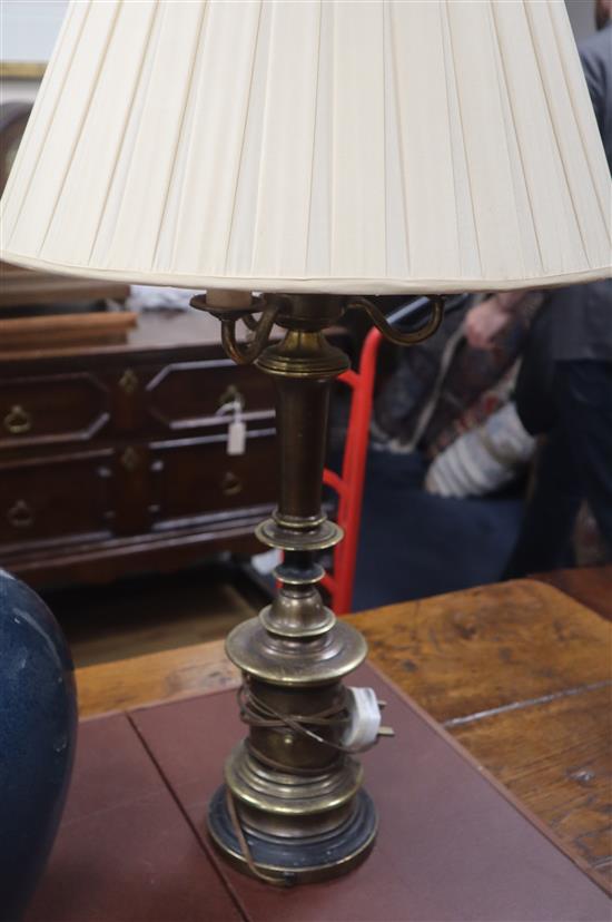 A pair of large bronzed metal three branch table lamps